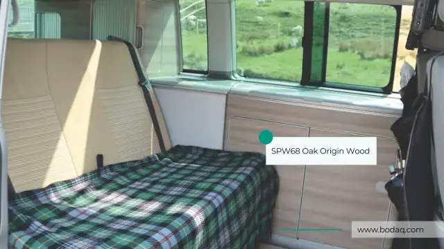 Camper van interior with pale oak film on the cabinetry