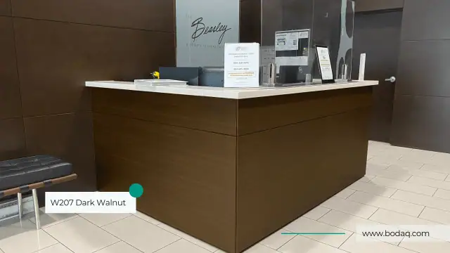 Reception desk front finished in a dark walnut film